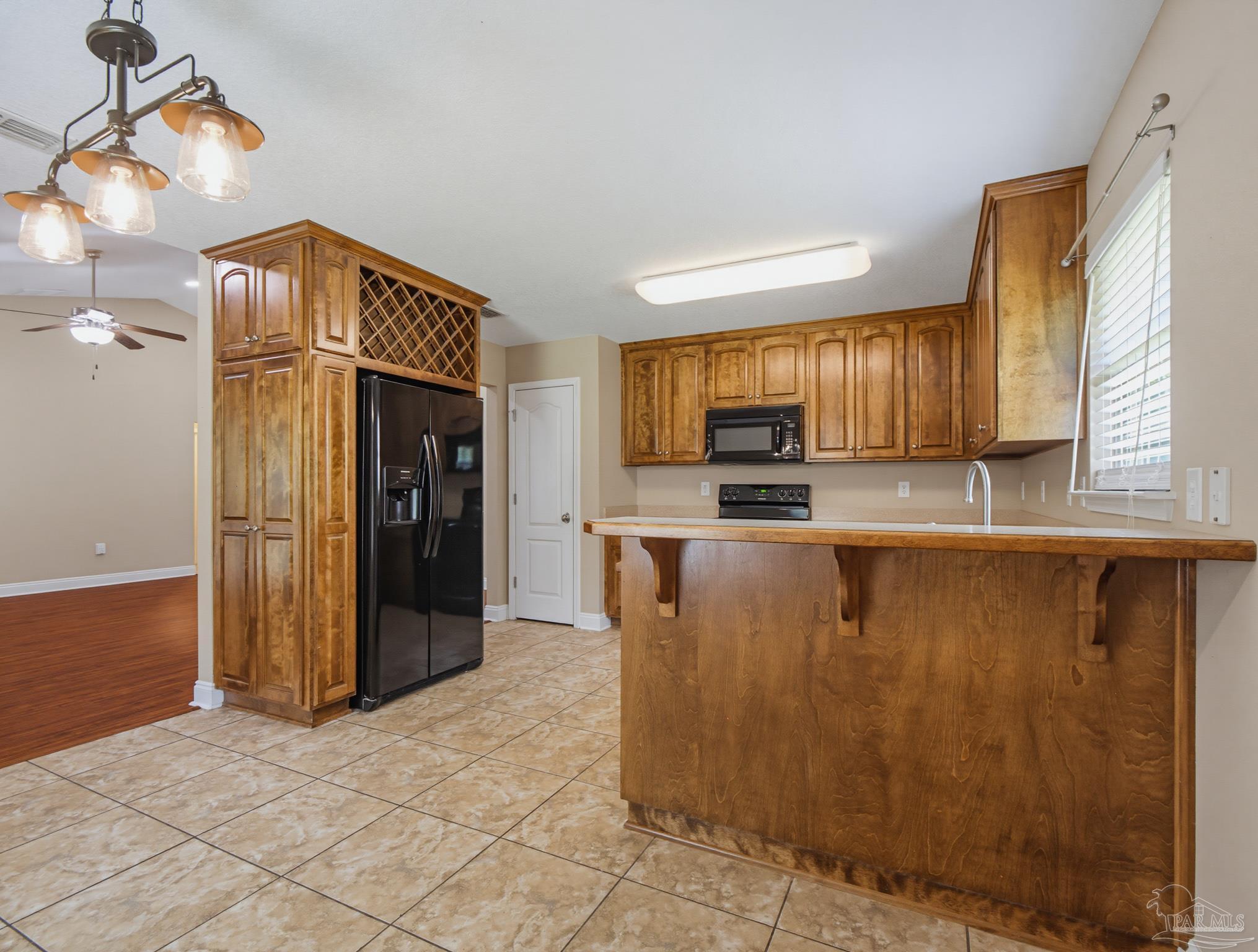 5567 Jones Street Milton, FL 32570 - Photo 15 of 48 a kitchen with stainless steel appliances granite countertop a refrigerator and a sink