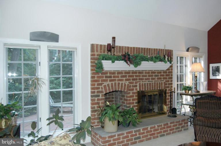 3731 North Glebe Road Arlington, VA 22207 - Photo 11 of 27 a living room with furniture a fireplace and a floor to ceiling window