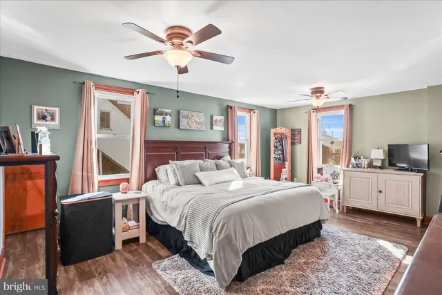 a bedroom with a large bed and a chandelier