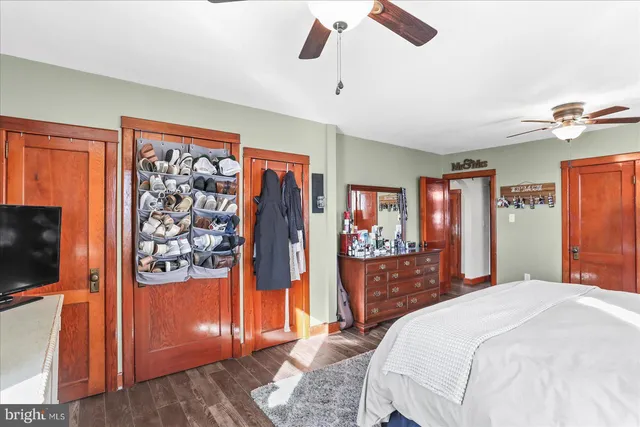 a bedroom with a large bed and a chandelier