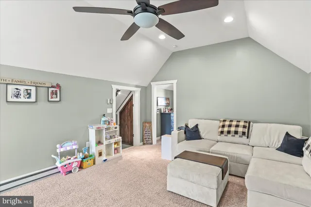 a bedroom with furniture and a chandelier fan