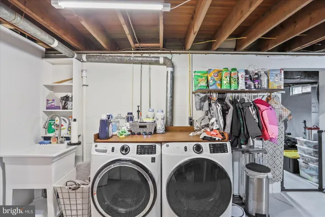a view of a storage and utility room with washer and dryer