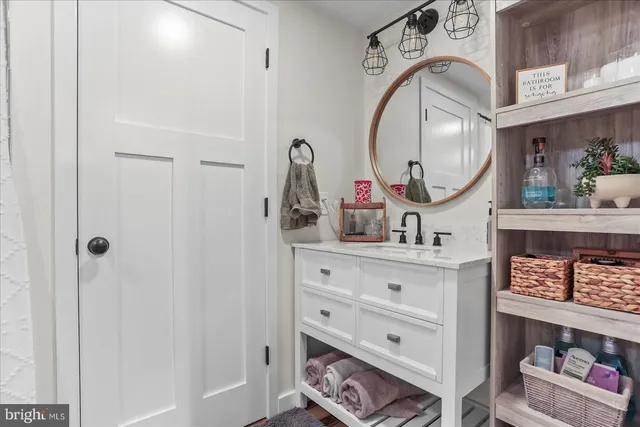 a bathroom with a sink a vanity and a mirror