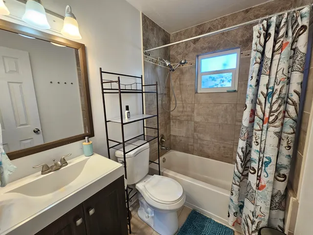 a bathroom with a sink toilet and shower