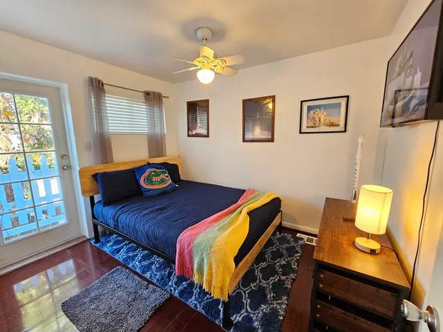 a bedroom with a bed and wooden floor
