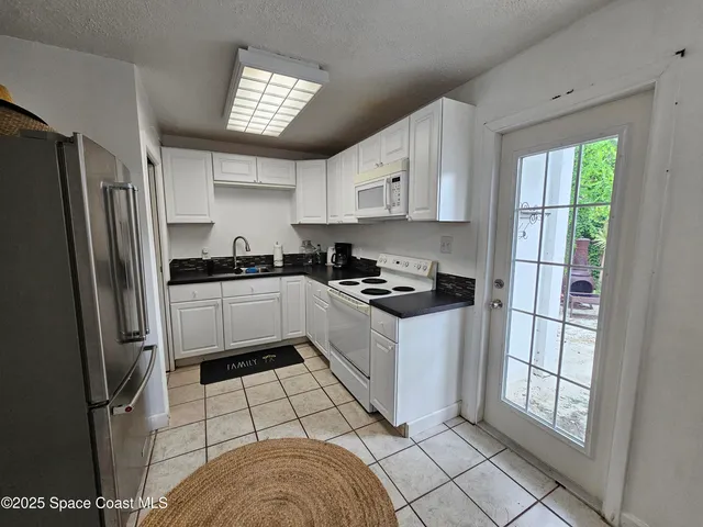 a kitchen with stainless steel appliances a refrigerator sink and cabinets