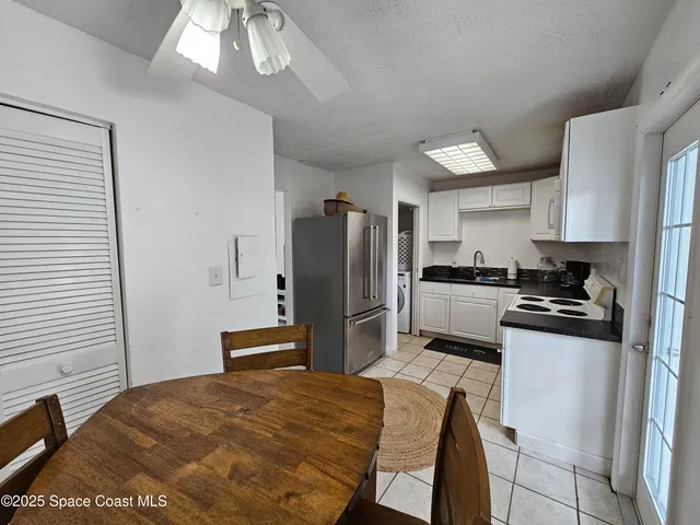 a kitchen with a refrigerator and a stove top oven