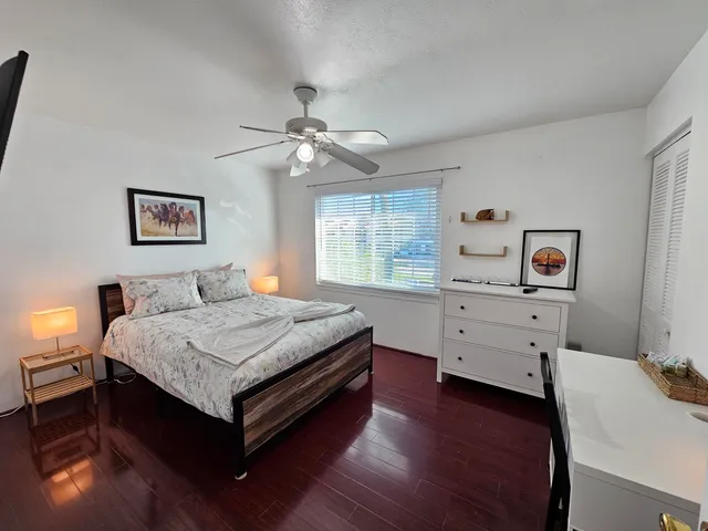 a bedroom with a bed and a desk