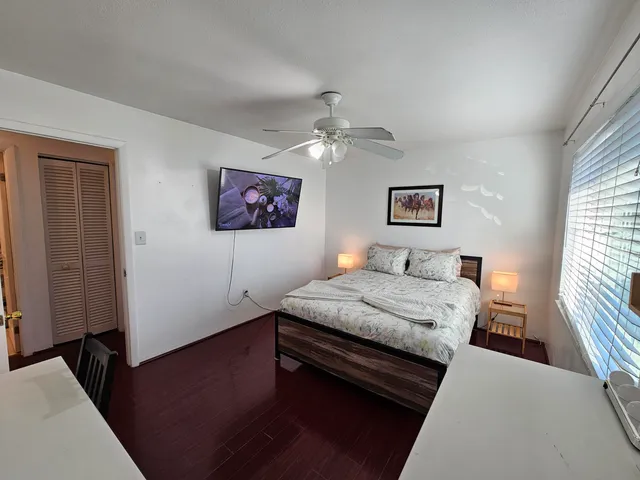 a bedroom with a bed and a window