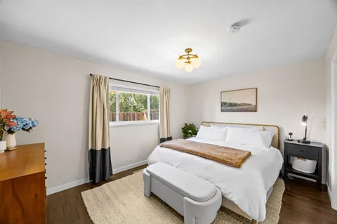 a bed sitting in a bedroom next to a window