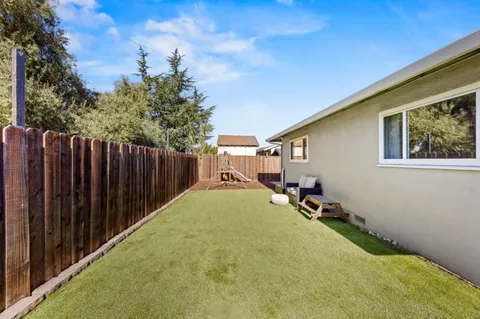 a view of a backyard with wooden fence