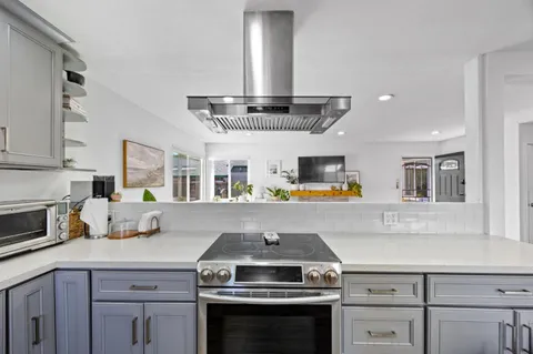 a kitchen with a stove and a sink