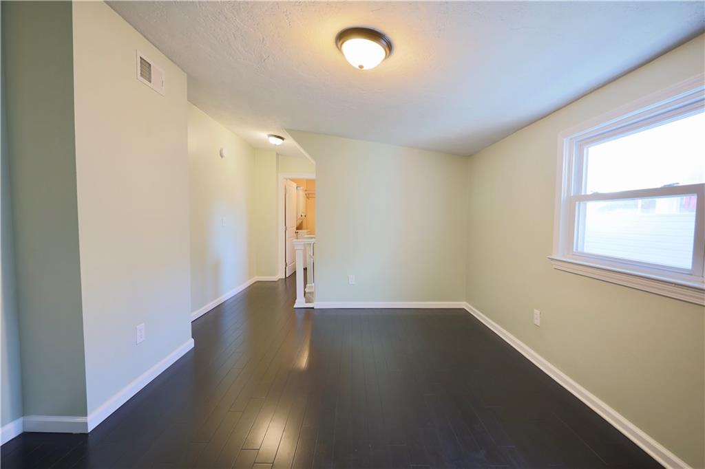 513 Lockhart Street, Unit 2 Pittsburgh, PA 15212 - Photo 11 of 21 an empty room with wooden floor and windows