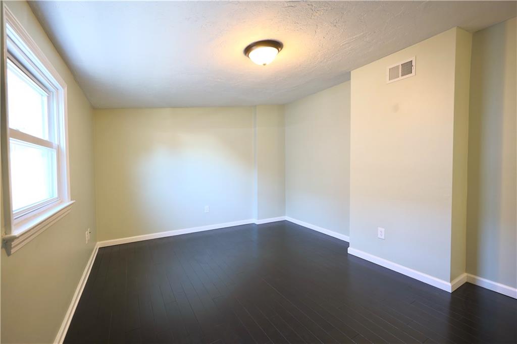 513 Lockhart Street, Unit 2 Pittsburgh, PA 15212 - Photo 12 of 21 an empty room with wooden floor and windows