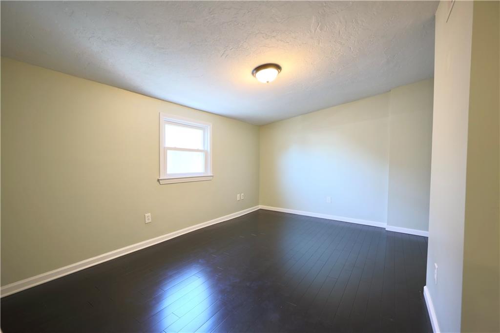 513 Lockhart Street, Unit 2 Pittsburgh, PA 15212 - Photo 13 of 21 an empty room with wooden floor and windows