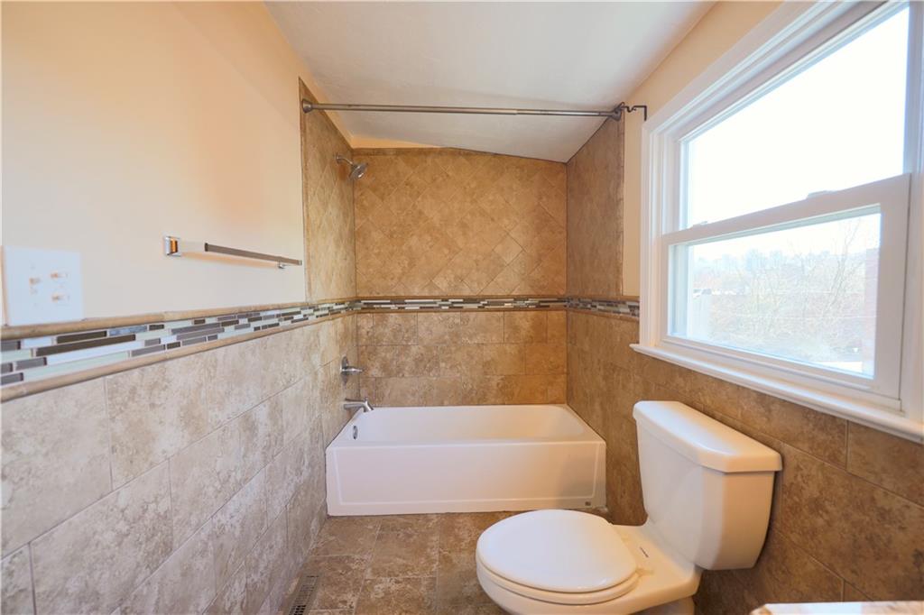 513 Lockhart Street, Unit 2 Pittsburgh, PA 15212 - Photo 16 of 21 a bathroom with a toilet and a shower