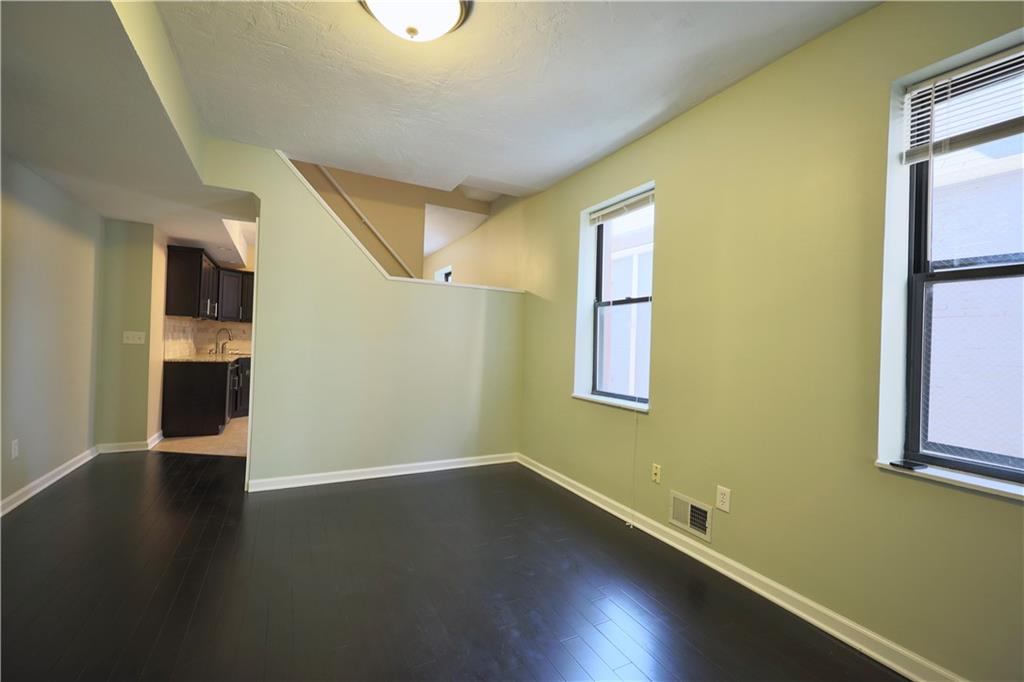 513 Lockhart Street, Unit 2 Pittsburgh, PA 15212 - Photo 3 of 21 a view of empty room with wooden floor and fan