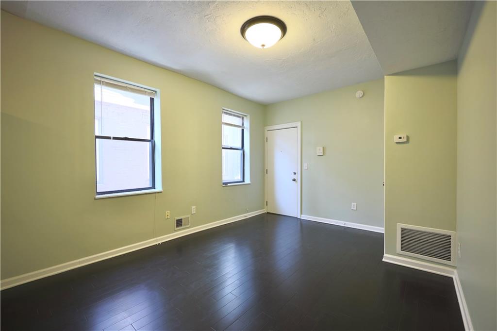 513 Lockhart Street, Unit 2 Pittsburgh, PA 15212 - Photo 5 of 21 an empty room with wooden floor and windows