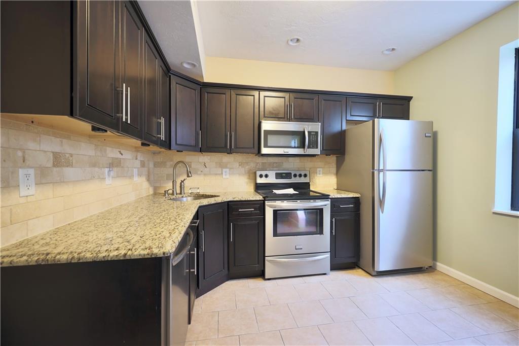 513 Lockhart Street, Unit 2 Pittsburgh, PA 15212 - Photo 7 of 21 a kitchen with a refrigerator sink and microwave