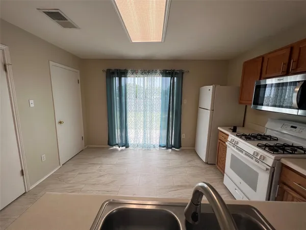 a kitchen with a sink stove and cabinets