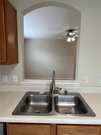 a kitchen with a sink stove and cabinets