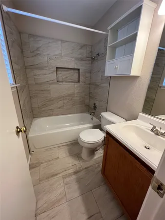 a bathroom with a sink a toilet and bathtub