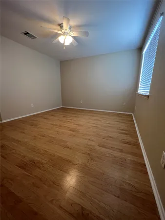 a view of a room with wooden floor and white walls
