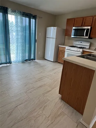 a kitchen with a refrigerator sink and microwave