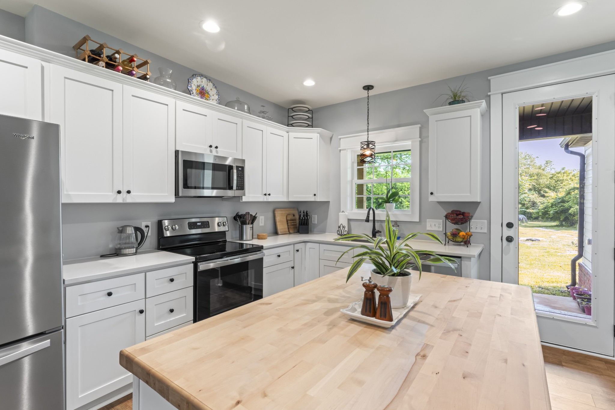 1510 Wade Brown Road Lewisburg, TN 37091 - Photo 28 of 59 a kitchen with stainless steel appliances granite countertop a refrigerator a stove top oven a sink a counter space and cabinets