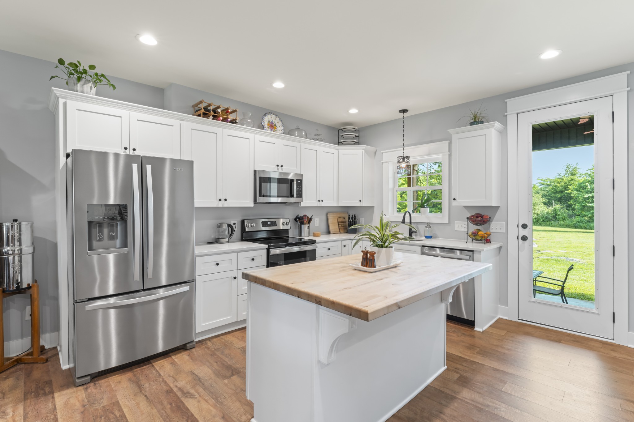 1510 Wade Brown Road Lewisburg, TN 37091 - Photo 29 of 59 a kitchen with a refrigerator a stove a sink and a dining table with wooden floor