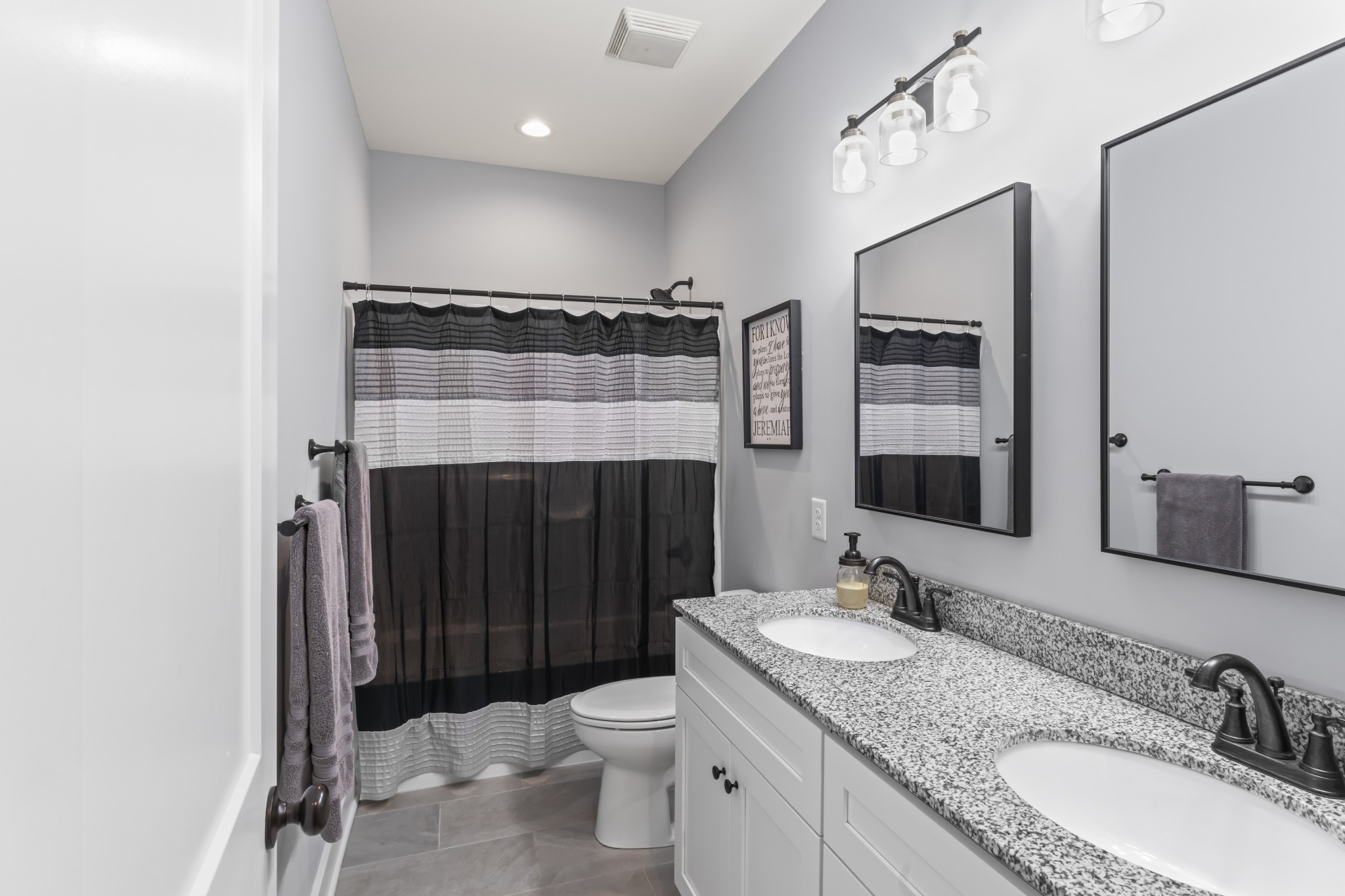 1510 Wade Brown Road Lewisburg, TN 37091 - Photo 45 of 59 a bathroom with a granite countertop sink a toilet a mirror and shower