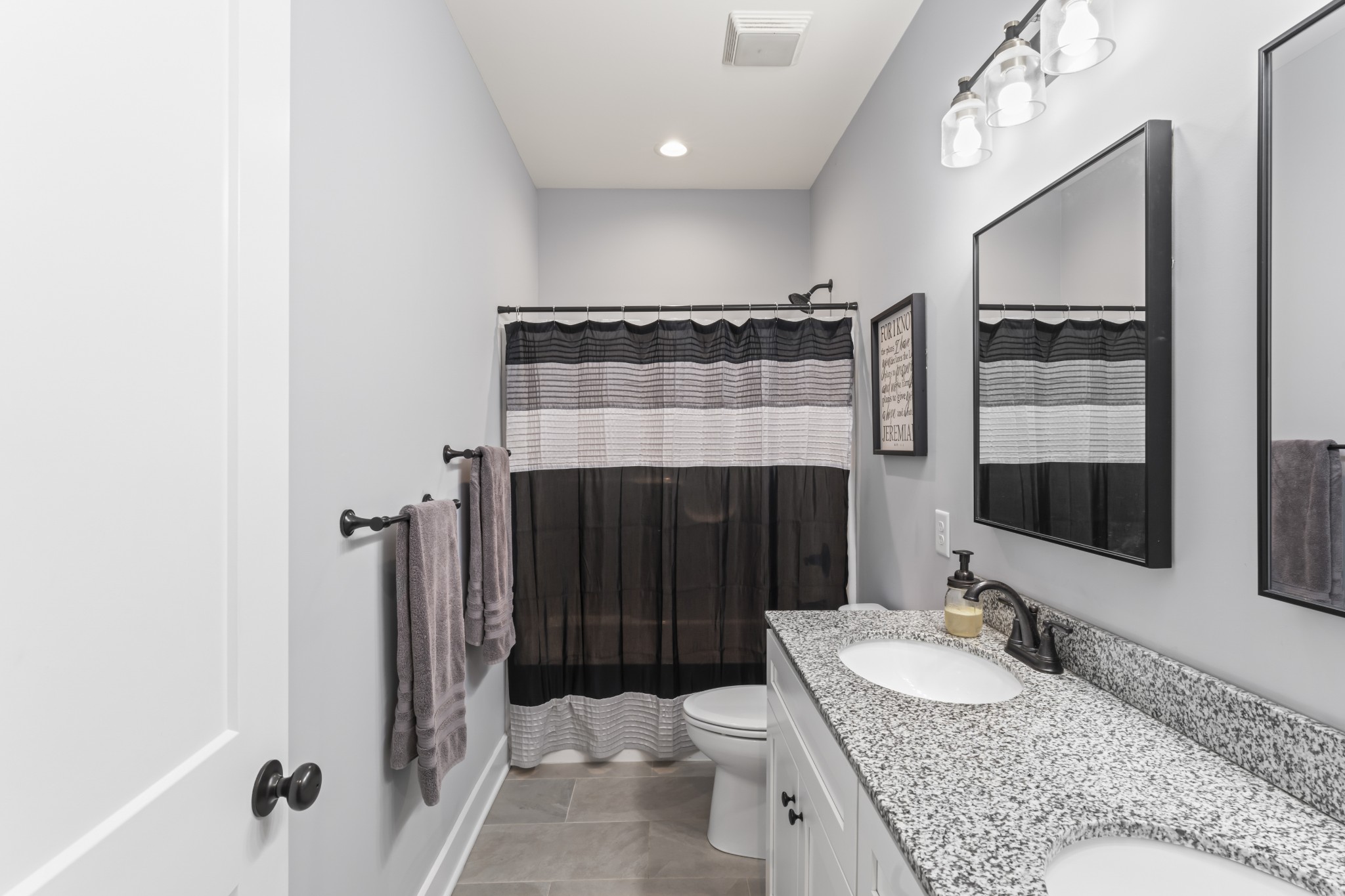 1510 Wade Brown Road Lewisburg, TN 37091 - Photo 46 of 59 a bathroom with a granite countertop sink a toilet a mirror and shower