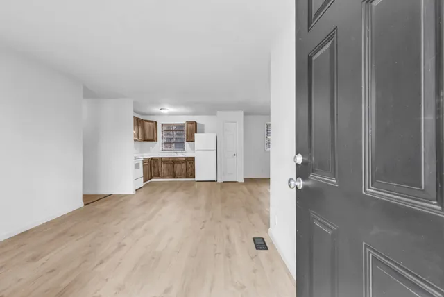 a view of empty room with wooden floor and cabinet