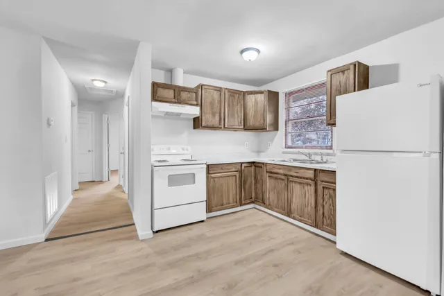 a kitchen with a white stove top oven and refrigerator