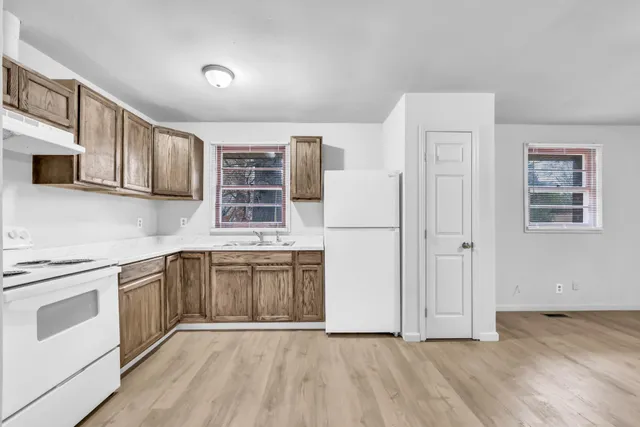 a kitchen with stainless steel appliances granite countertop a stove a sink and a refrigerator