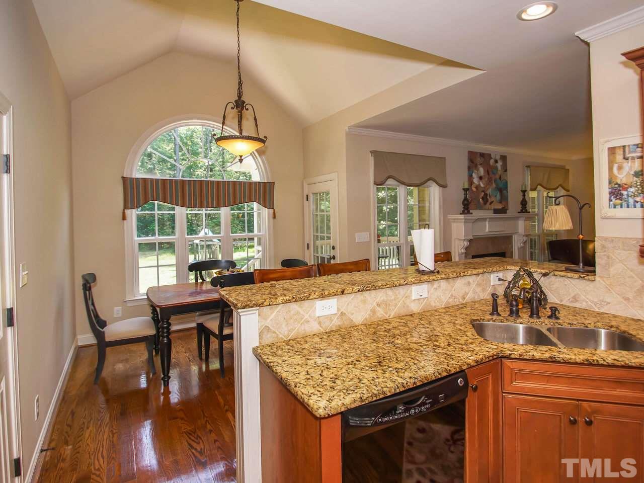 10001 Fanny Brown Road Raleigh, NC 27603 - Photo 11 of 25 a living room with granite countertop kitchen island furniture and a chandelier
