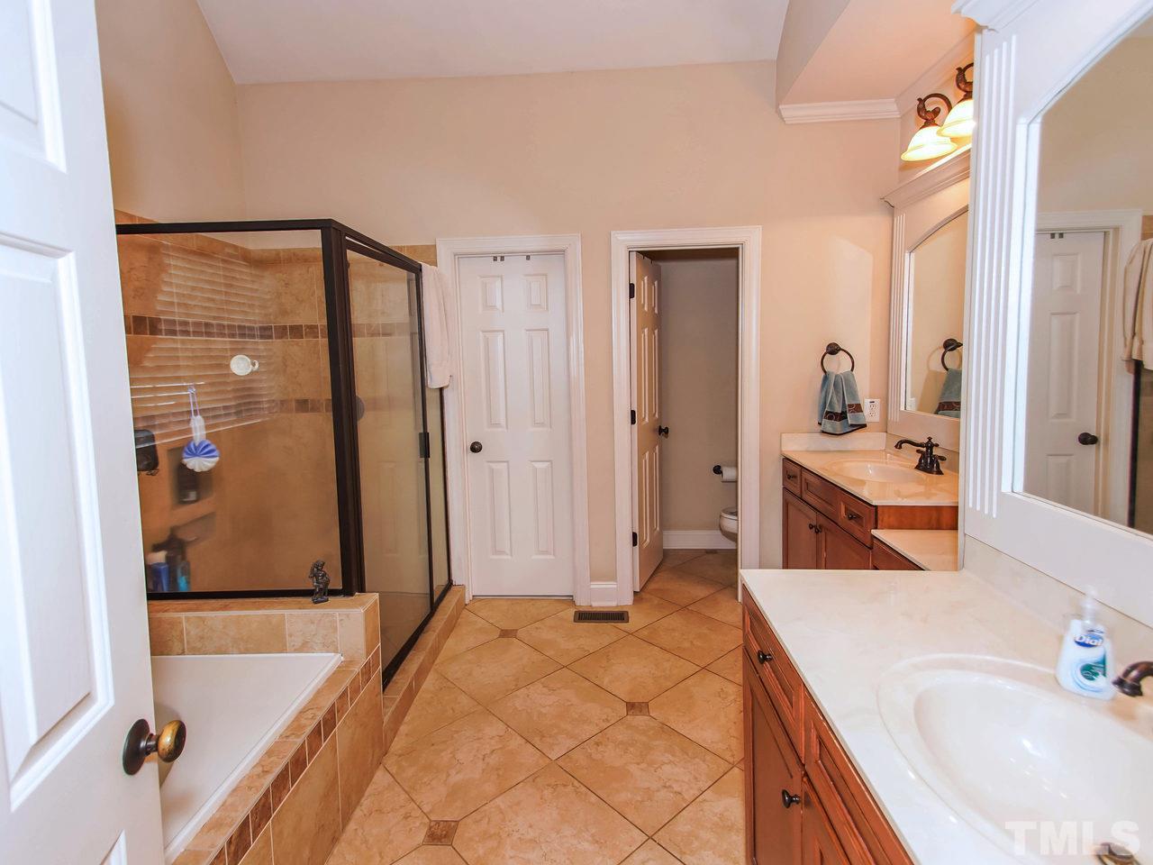 10001 Fanny Brown Road Raleigh, NC 27603 - Photo 13 of 25 a spacious bathroom with a tub sink and mirror