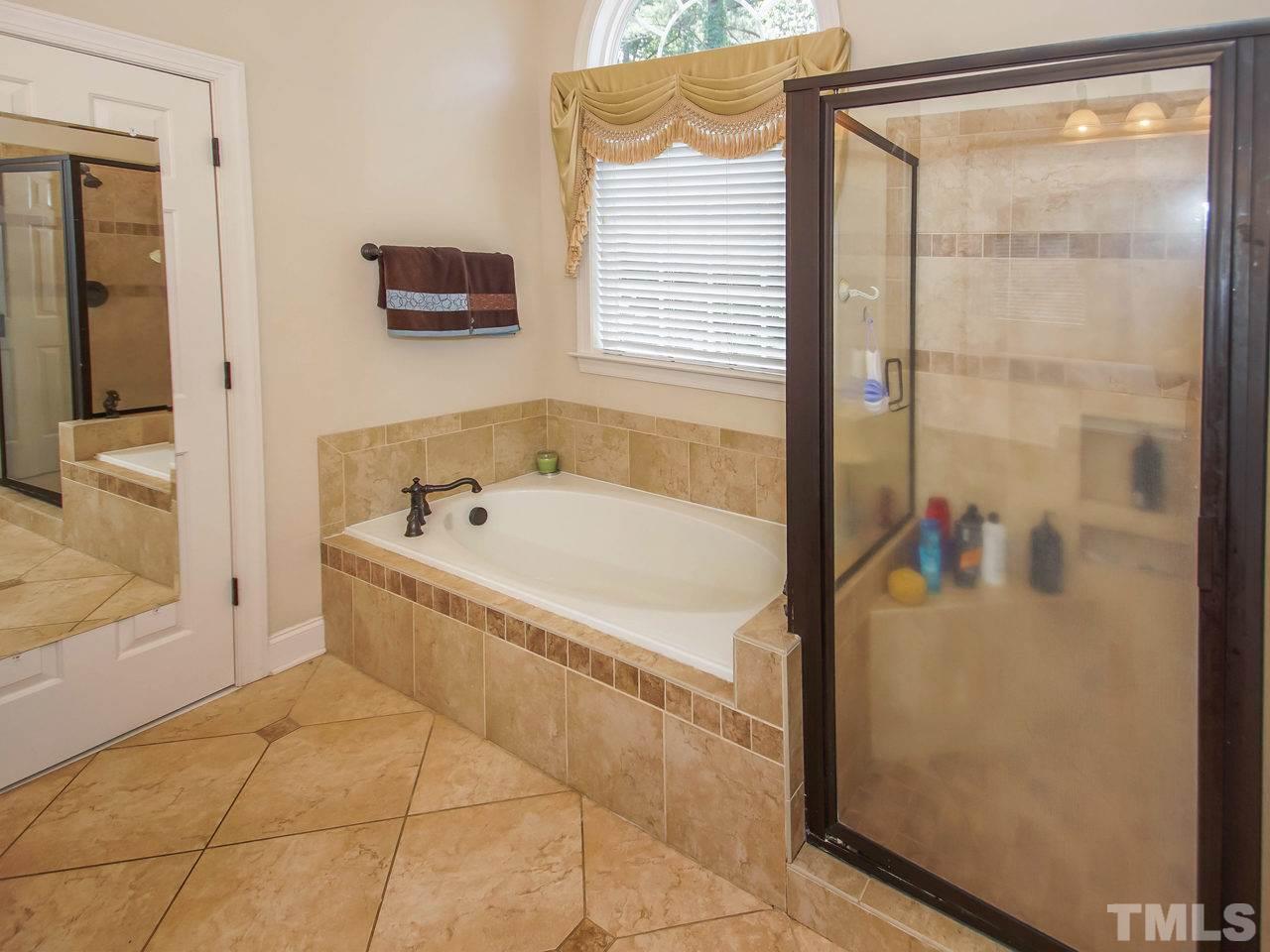 10001 Fanny Brown Road Raleigh, NC 27603 - Photo 14 of 25 a spacious bathroom with a bathtub and a shower