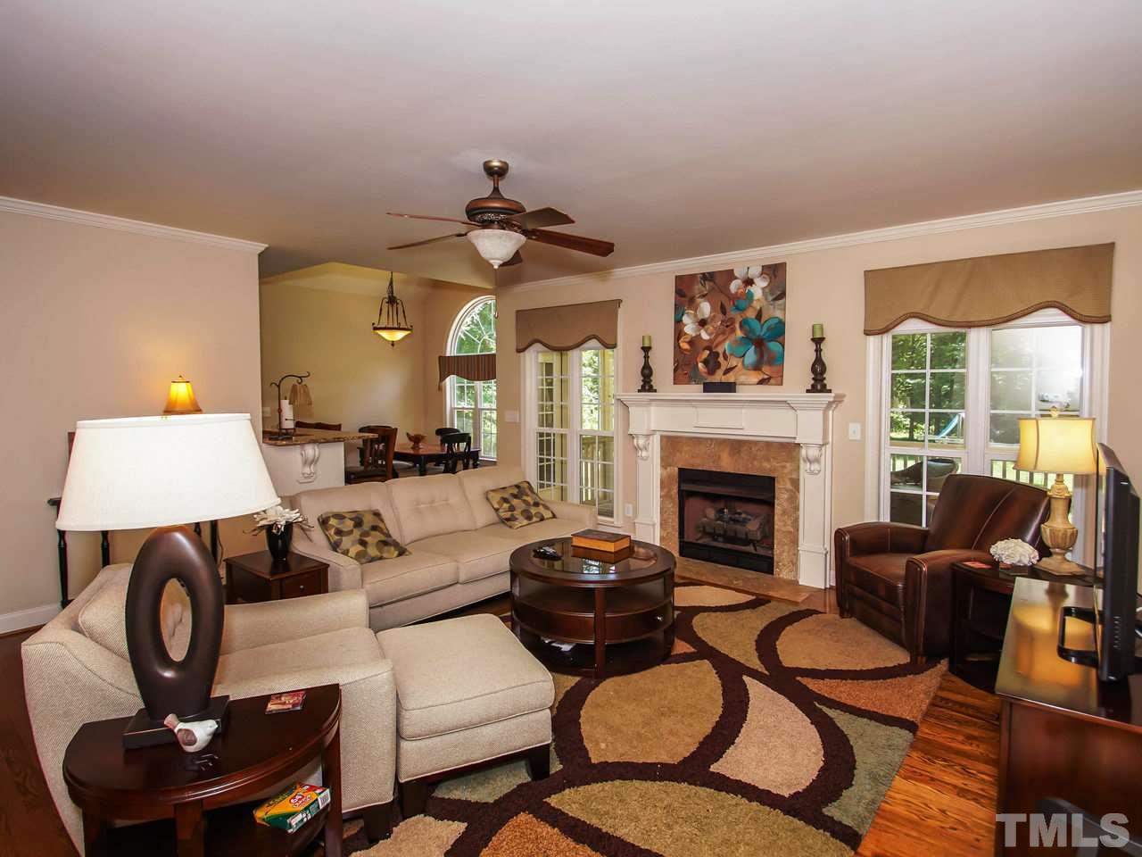 10001 Fanny Brown Road Raleigh, NC 27603 - Photo 5 of 25 a living room with furniture a fireplace and a large mirror
