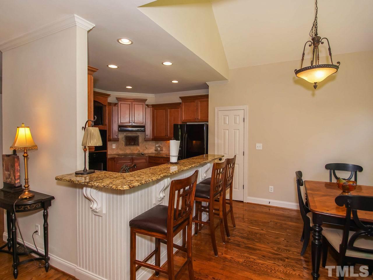 10001 Fanny Brown Road Raleigh, NC 27603 - Photo 7 of 25 a view of a dining room with furniture and wooden floor