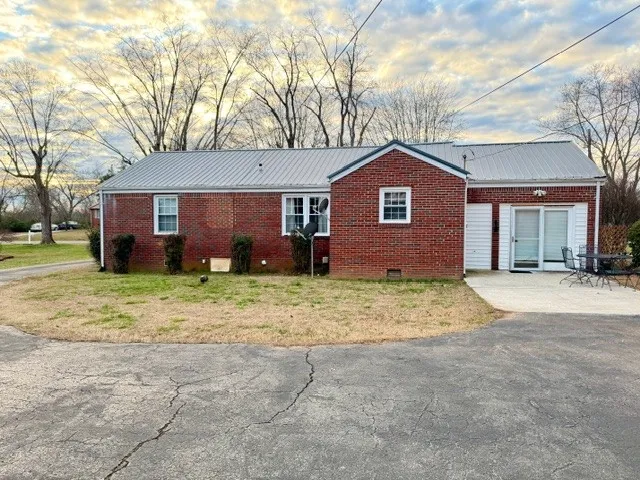 a brick house with a large space in front of it