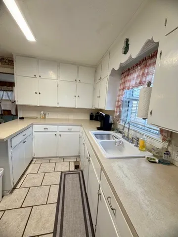 a kitchen with a sink stove and cabinets