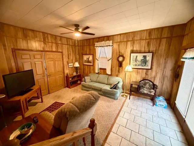 a bedroom with furniture and a flat screen tv