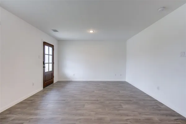 wooden floor in a hall with a window