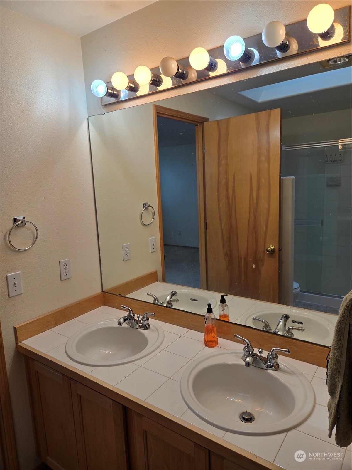 600 Northwest 3rd Court Renton, WA 98057 - Photo 15 of 28 a bathroom with a sink and a mirror