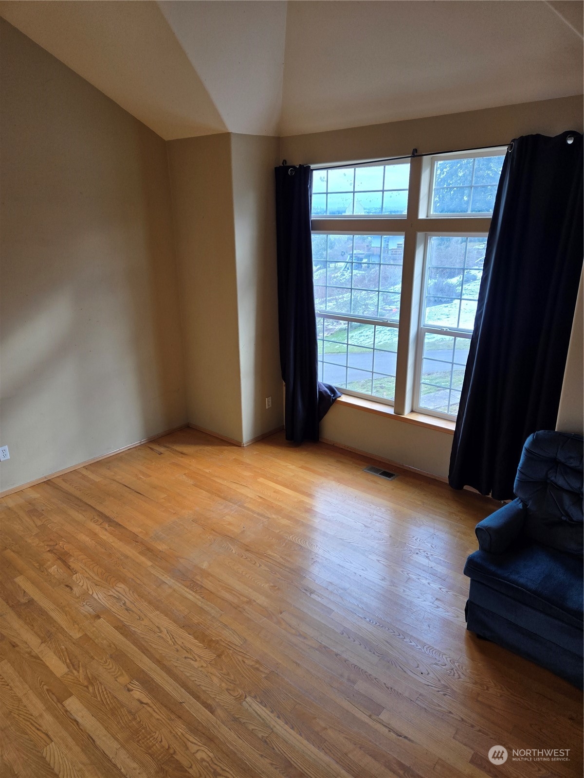 600 Northwest 3rd Court Renton, WA 98057 - Photo 4 of 28 a view of an empty room with a window and wooden floor