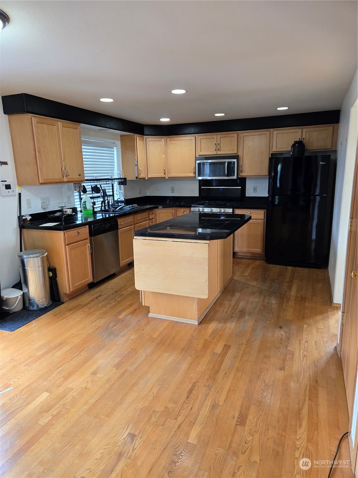 600 Northwest 3rd Court Renton, WA 98057 - Photo 6 of 28 a kitchen with stainless steel appliances granite countertop a stove a sink and a refrigerator