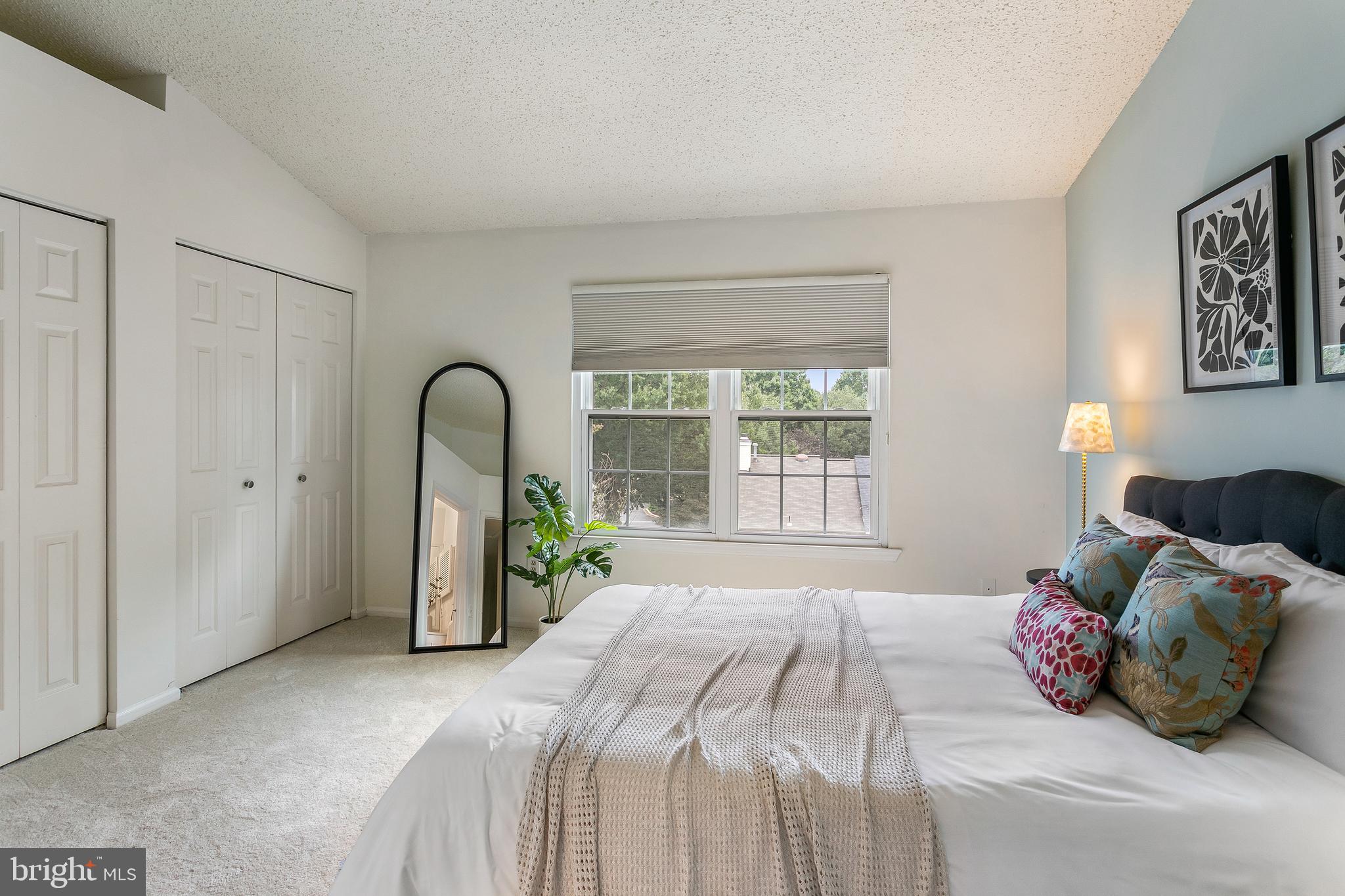 6542 Cypress Point Road Alexandria, VA 22312 - Photo 16 of 31 a bedroom with a bed and a large window