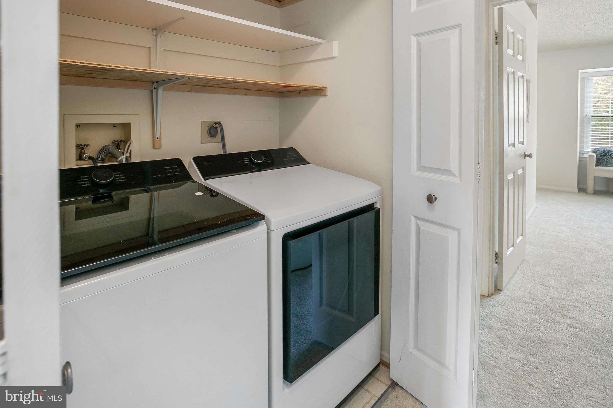 6542 Cypress Point Road Alexandria, VA 22312 - Photo 19 of 31 a kitchen with stainless steel appliances a refrigerator and cabinets