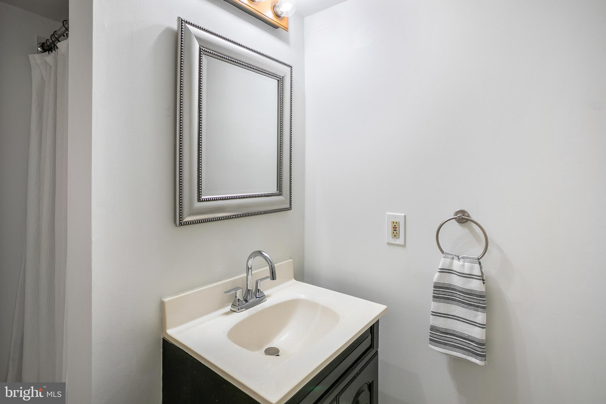 6542 Cypress Point Road Alexandria, VA 22312 - Photo 23 of 31 a bathroom with a sink and a mirror